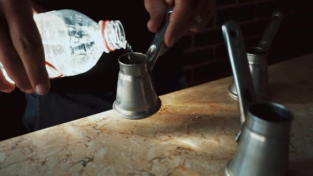 Traditional process of making Turkish coffee in a copper cezve on hot sand. Close-up of brewing coffee with foam rising, authentic oriental preparation method