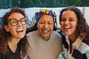 Portrait of multi generational women smiling on camera outdoor - African mother and daughter with...