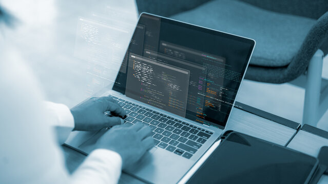 Software development and computer programming.Digital technology and internet security engineering.Professional web developer coding on laptop screen.Hands typing on keyboard for software engineering.