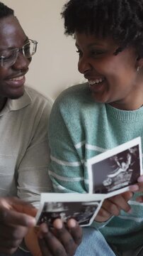 Expecting african american couple looking at ultrasound scan