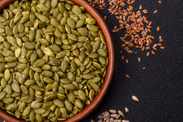 Fototapeta premium Shelled pumpkin seed kernels, salted, roasted, or raw, are a healthy ingredient. Pumpkin seeds