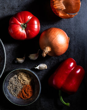 Raw vegetables on textured dark surface