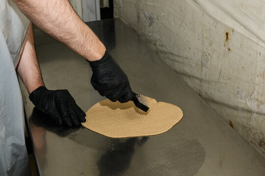 A worker at a matzah bakery in Jerusalem uses a special tool to score the uncooked dough prior to baking the matzah for the celebration of Passover in Israel.