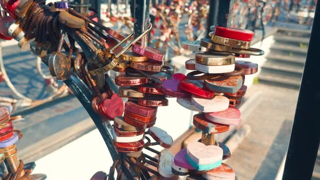 Heart shaped love locks symbolizing eternal romance and commitment, securely fastened to an urban bridge railing, representing travel traditions and lasting relationships