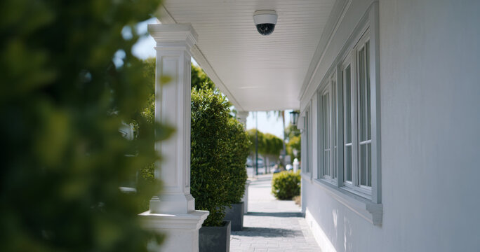 Residential porch with security camera and greenery