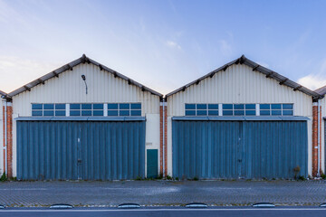 Fototapeta premium Symmetrical Industrial Warehouses with Blue Doors in Lisbon, Portugal