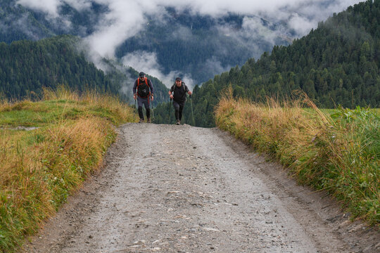 Tourists are going from the Val Gardena valley to the Puez-Odle Nature Park in the Dolomites, Italy.