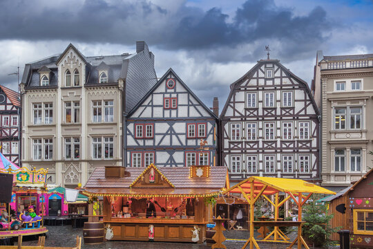 Christmas market on historic main square in Alsfeld Germany. Traditional wooden stalls under cloudy sky