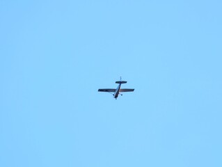 Fototapeta premium Quiet sky flight. An individual pilot navigates small aircraft through serene sky dotted with few clouds