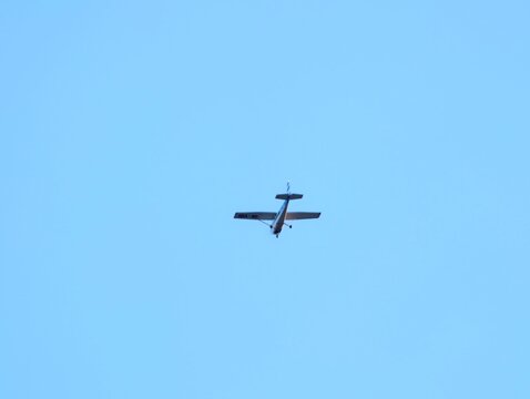 Quiet sky flight. An individual pilot navigates small aircraft through serene sky dotted with few clouds