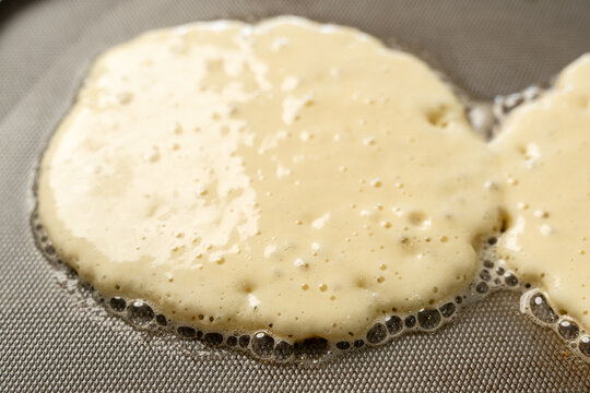 Pancakes cooking on griddle 