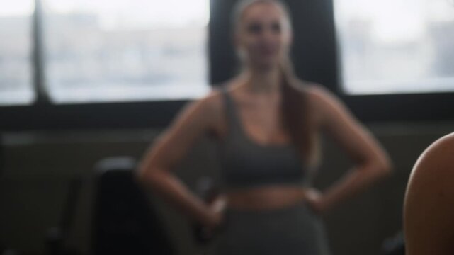 Medium shot of biracial young couple breathing heavily while resting after workout and chatting