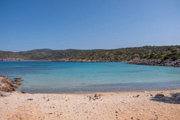 Obraz premium Agia Dynami Beach in Chios island, Greece. Sandy beach with emerald color waters and a chapel, blue summer sky