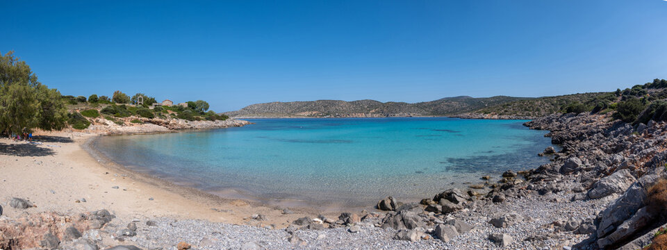 Agia Dynami Beach in Chios island, Greece. Sandy beach with emerald color waters and a chapel, blue summer sky