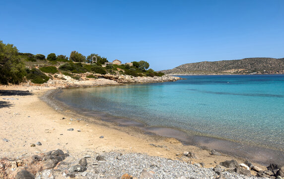 Agia Dynami Beach in Chios island, Greece. Sandy beach with emerald color waters and a chapel, blue summer sky