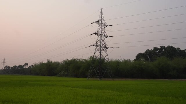 Transmission Tower in Rural Landscape at Sunset