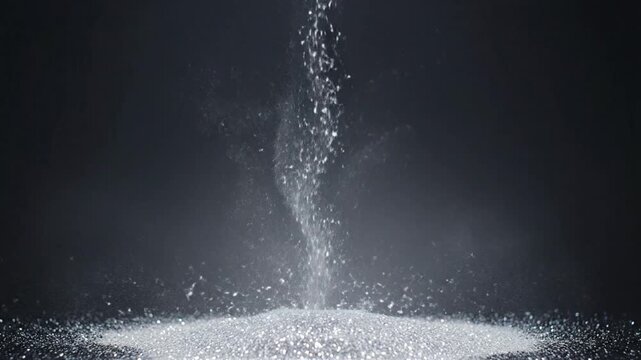Water vapor transforms into mist and settles on surface in dark studio environment