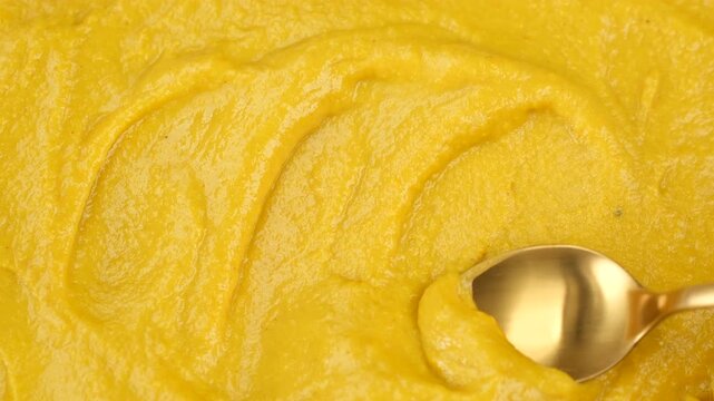 Classic mustard. Making swirl with spoon on mustard. Fresh, spicy yellow mustard paste