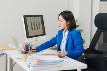 Focused Professional: An focused professional is working at desk, analyzing data. A scene of quiet productivity. © Wicitr