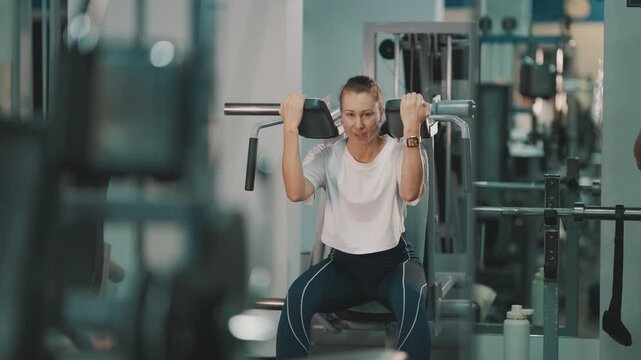 Strong woman training legs on hack squat machine