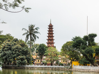 Traditional Vietnamese landmarks with intricate architecture, lush trees, and vibrant flowers....