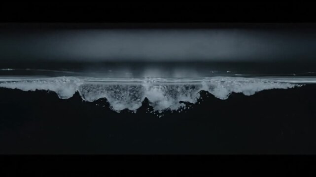 Bubbles forming and rising in dark liquid, close-up shot