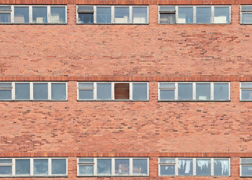 Red bricks and windows of an old mill