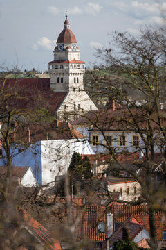 The Tower of the Parish Church of St. Michael the Archangel in Skalica, Slovakia, rising above traditional red roofs