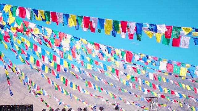 Handheld shot of prayer flags in front of Himalayas as seen from Padum town in Zanskar Valley, Ladakh, India. Buddhist prayer flags waving in the Himalayas.