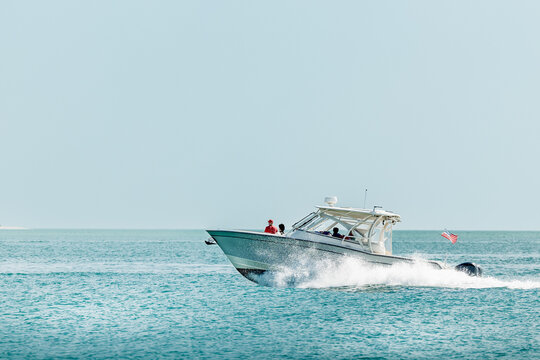 Saltwater fishing boat on a sunny summer day. People on recreational powerboat cruising the Gulf of America, Florida.