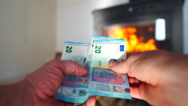 Heating payment. Save money wood stove. Euro money banknotes for payment of heating firewood. Budget wood heat home. Euro money pay for heating costs in heating season. Heat house in European Union EU
