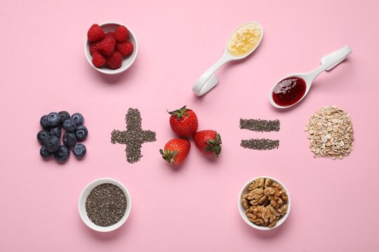 Math equation of oat flakes and other ingredients on pink background, flat lay