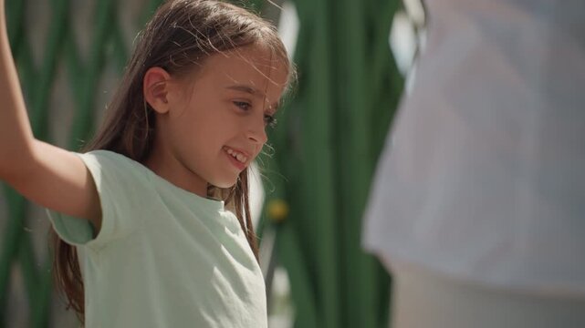 Child expresses faith and attachment by extending hand with warmth and love. Child openly displays trust and connection by tenderly reaching towards mother with affection and sincerity