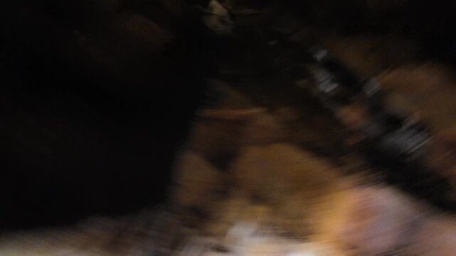 View of a Cave Cavern With Stone Walls and Dim Lighting