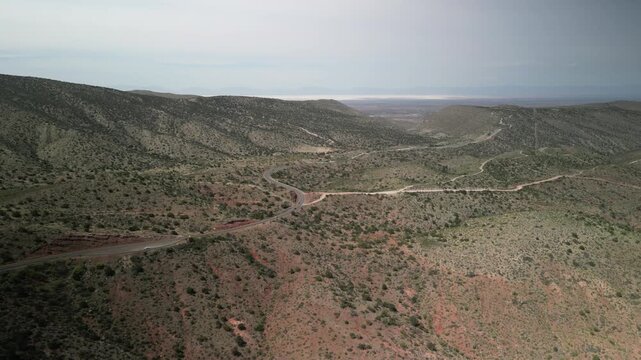 Aerial above canyon looking down towards Alamogordo New Mexico in high desert mountains