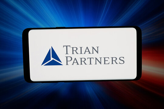 Stuttgart, Germany - 03-31-2026: In this photo illustration, the logo of Trian Fund Management LP (Trian Partners) is displayed on a smartphone in front of abstract background on computer screen.