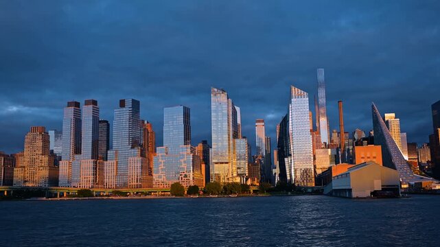 Modern skyline of Manhattan, a borough of New York City, US. Numerous towering skyscrapers over the river at sunset.