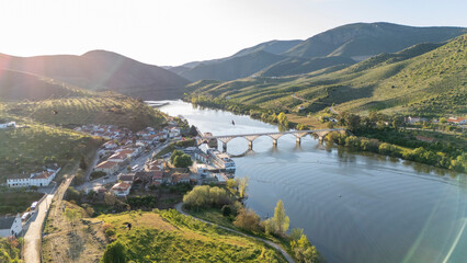 Douro river valley landscape with village and bridge © Barosanu