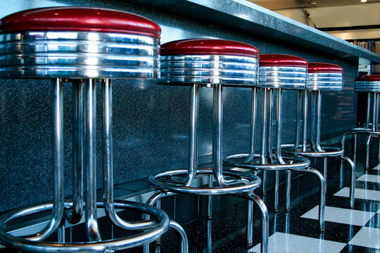 Retro diner bar stools in classic American restaurant interior

