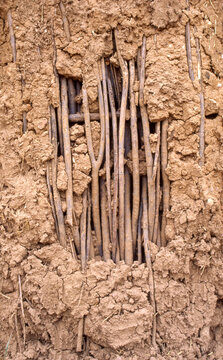Adobe Wall Texture with Exposed Embedded Wooden Sticks Rustic Background