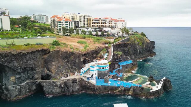 Aerial summer view of Doca do Cavacas in Madeira, capturing turquoise waters, moored boats, and vibrant coastal scenery