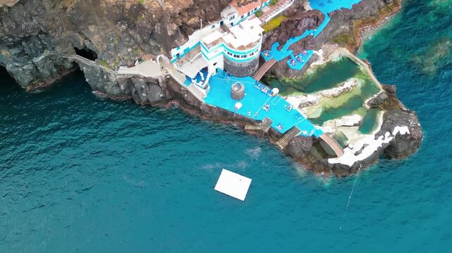 Dramatic aerial drone view of Doca do Cavacas natural volcanic pools and rugged Madeira cliffs