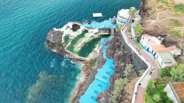Aerial summer view of Doca do Cavacas in Madeira, capturing turquoise waters, moored boats, and vibrant coastal scenery