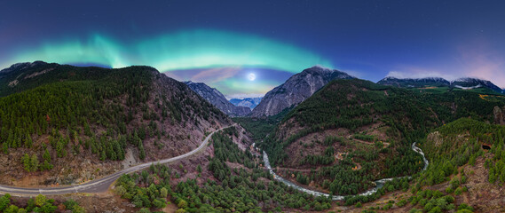 Northern Lights Over Mountain Valley With Winding Road and River Under Moonlit Sky © edb3_16