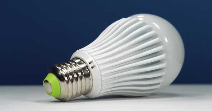 Large bright LED lamp with E27 base on dark blue background