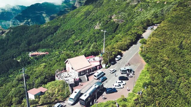 Stunning bird's eye perspective of Encumeada mountain pass showcasing lush green slopes and Atlantic horizon in Madeira Portugal