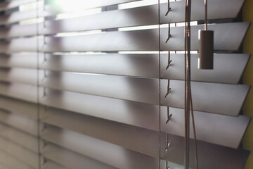 Window with closed blinds indoors, closeup view