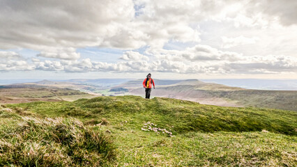 Obraz premium Backpack hiker in Beautiful landscape of Waun Fach, located at Brecon Beacons in Wales