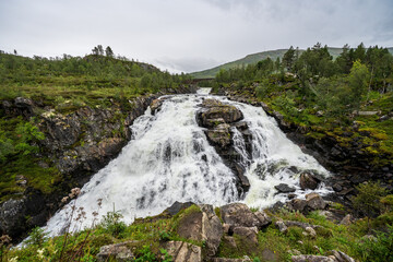 Obraz premium Powerful waterfall in the wild Norwegian landscape, Hardangervidda
