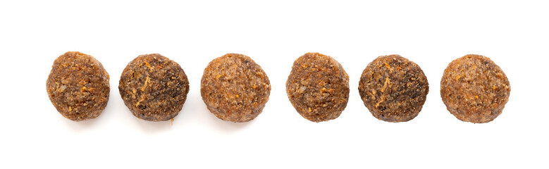 Naklejka premium Dry pet food macro pieces isolated, cat kibble closeup, dog pellets, small protein croquettes